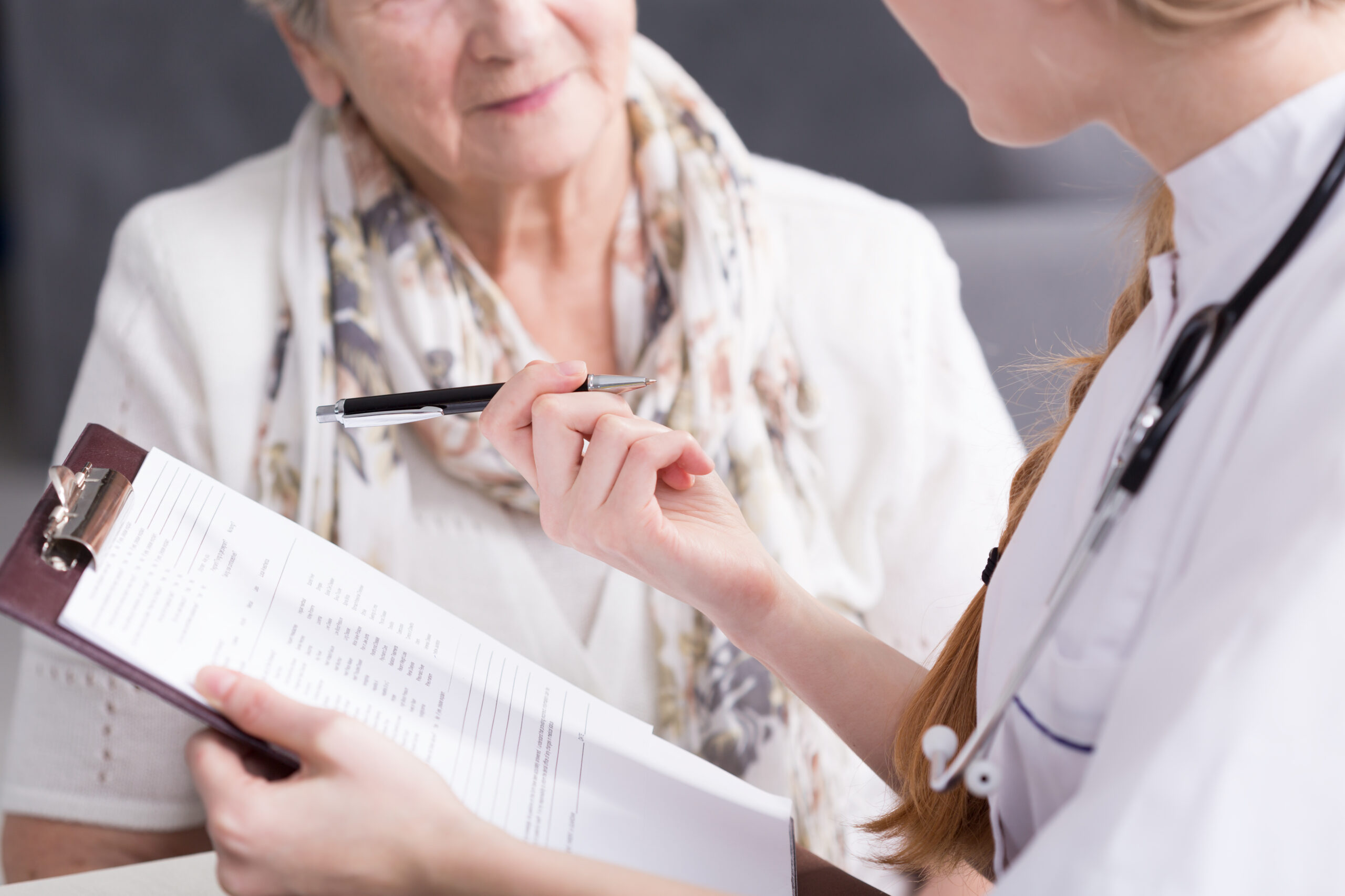 Physician doing medical interview doctor reviewing lab results with a patient