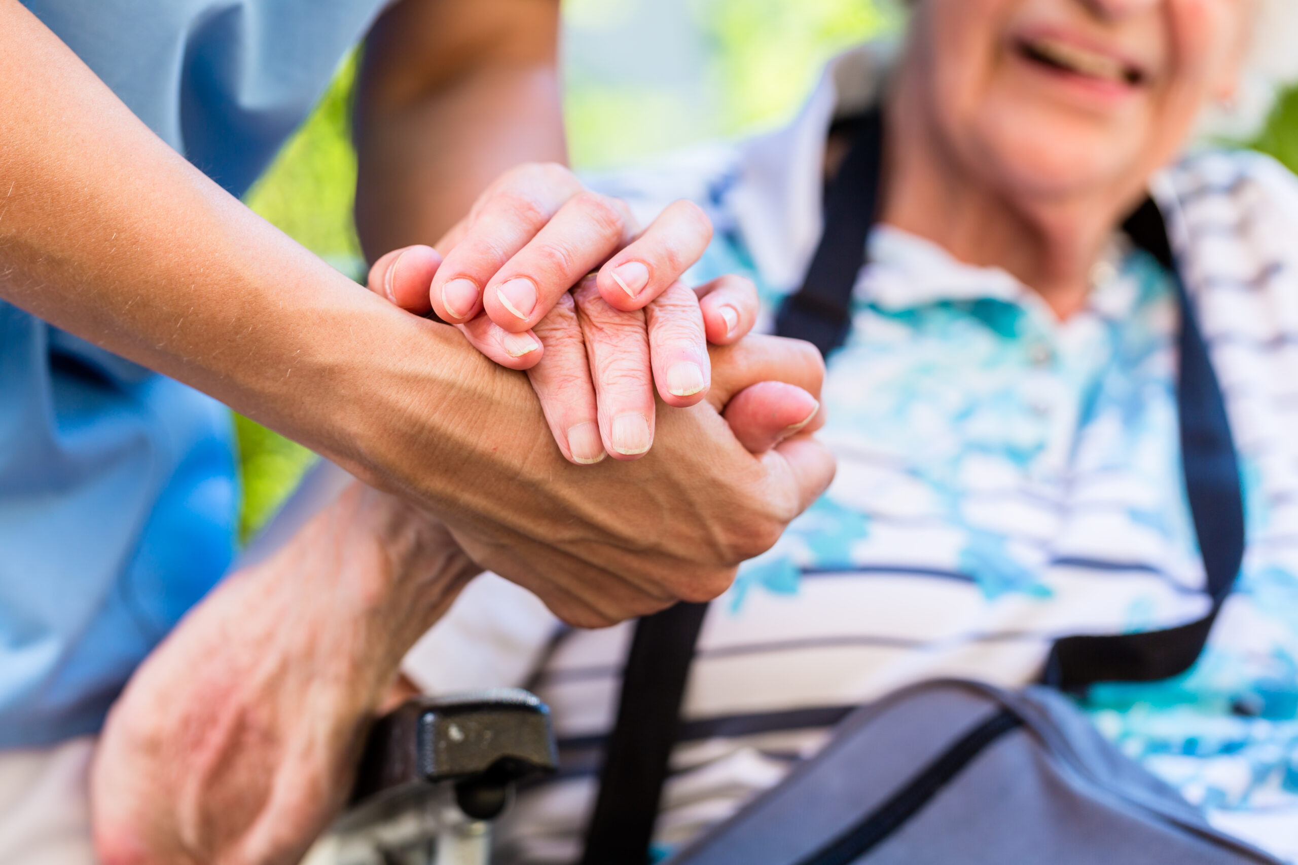 Nurse consoling senior woman holding her hand nurse with a senior patient