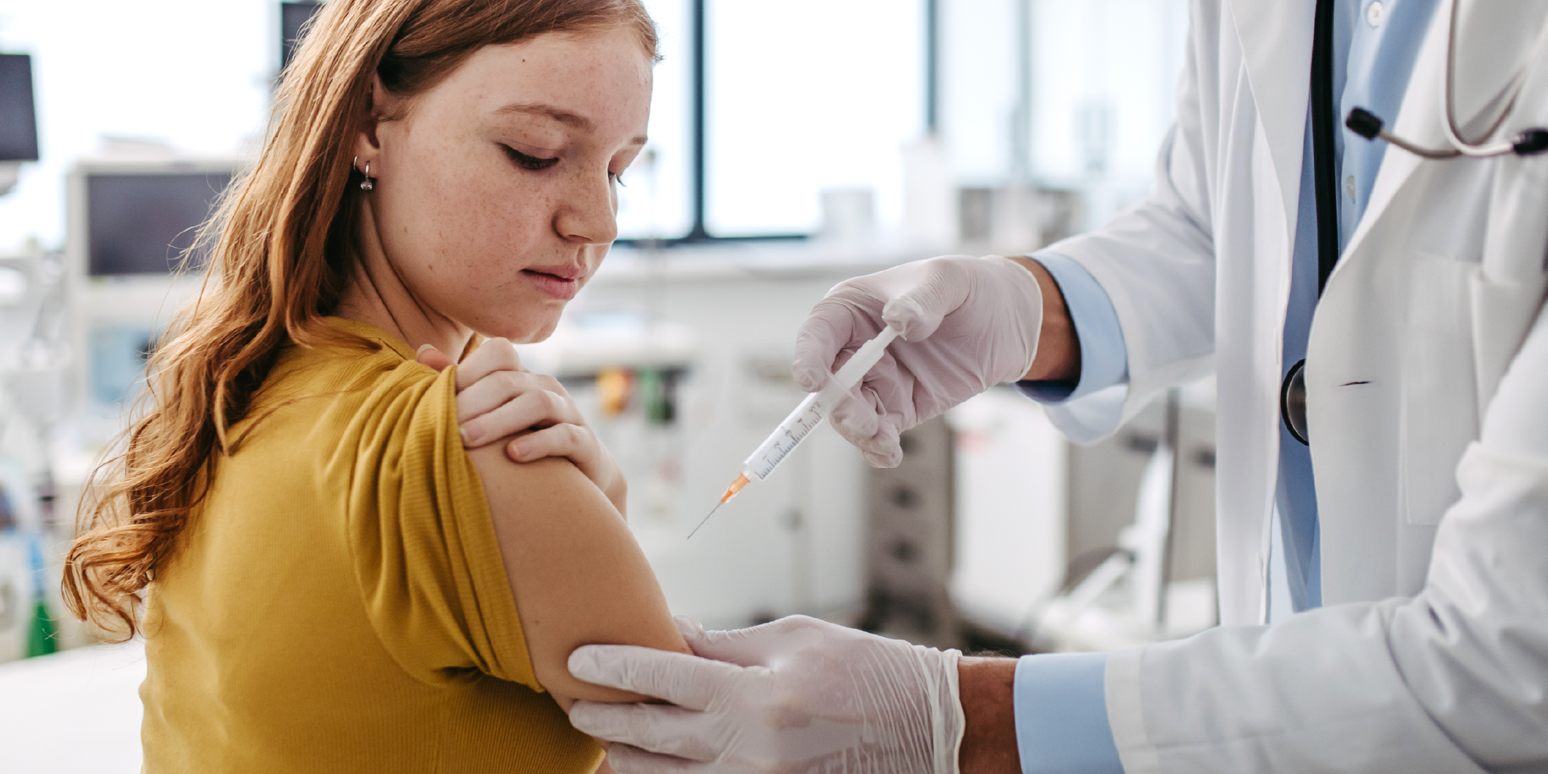 young girl receiving a vaccine