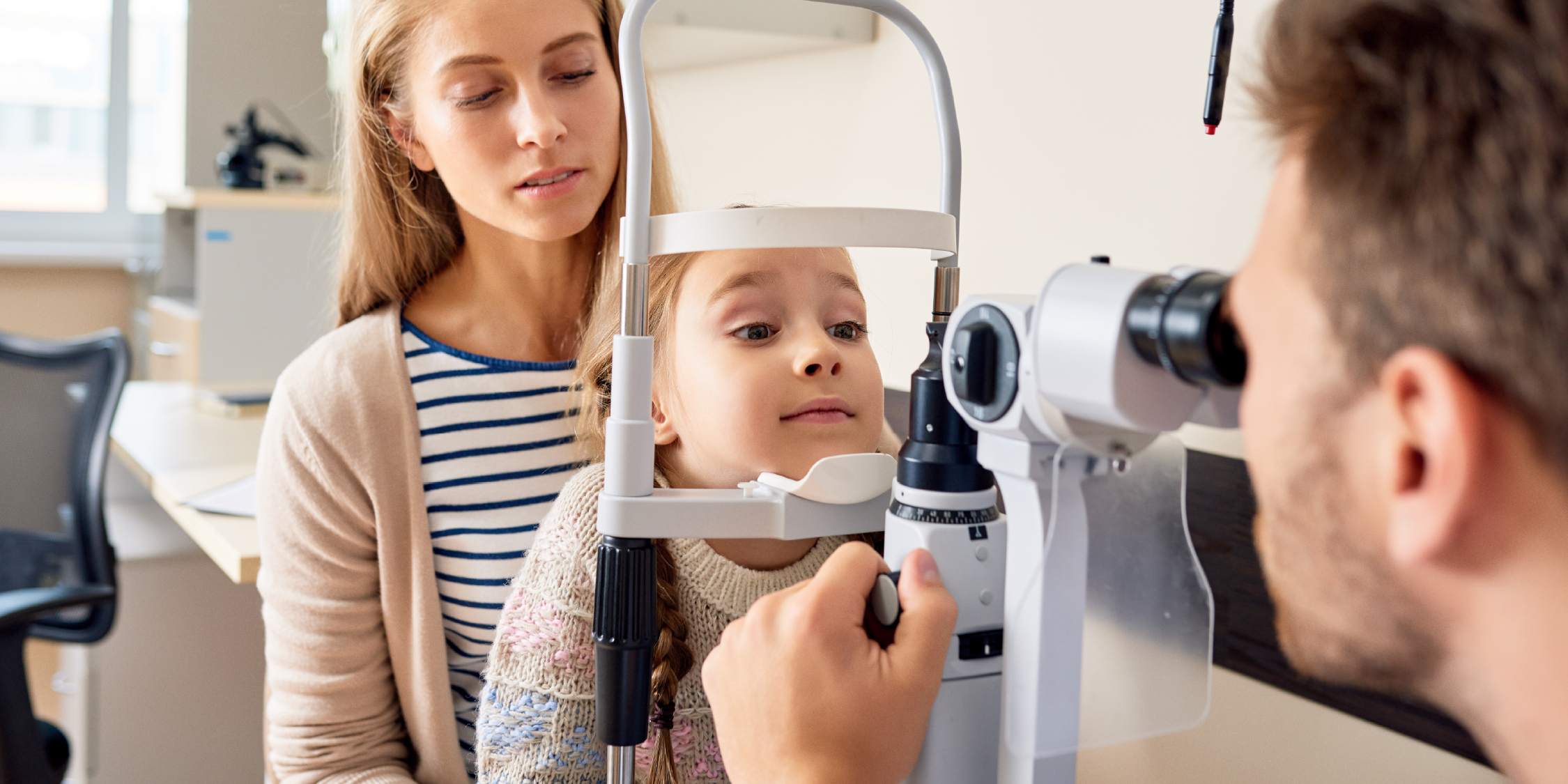 doctor performing a vision screening on a child 